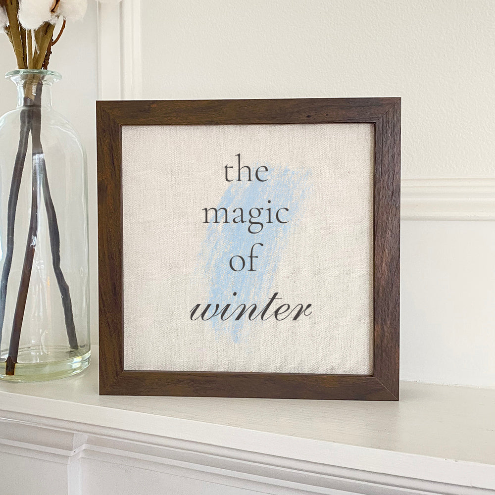 Magic of Winter framed sign with a stylized wood frame, featuring a linen-look background and eco-friendly printing.