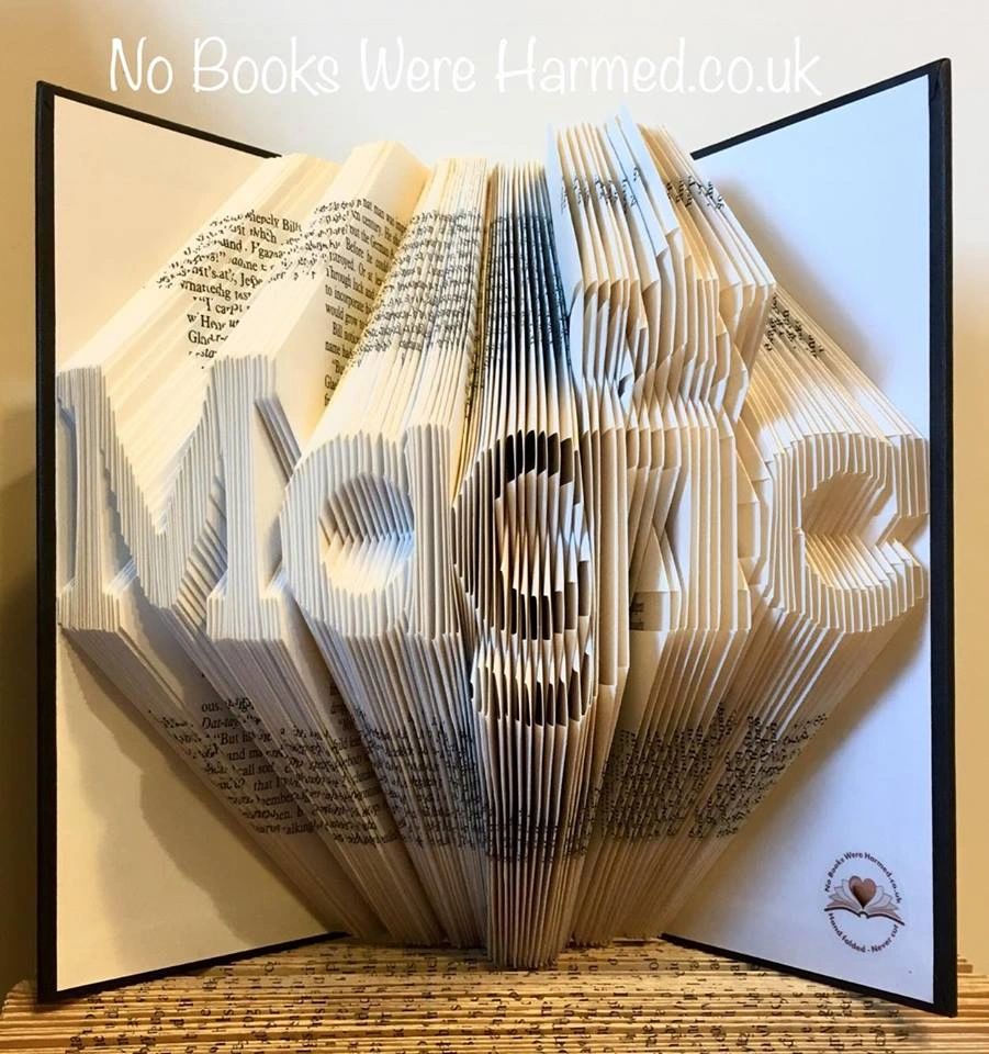 Unique hand-folded book art made from reclaimed vintage books, showcasing intricate designs and vibrant colors.