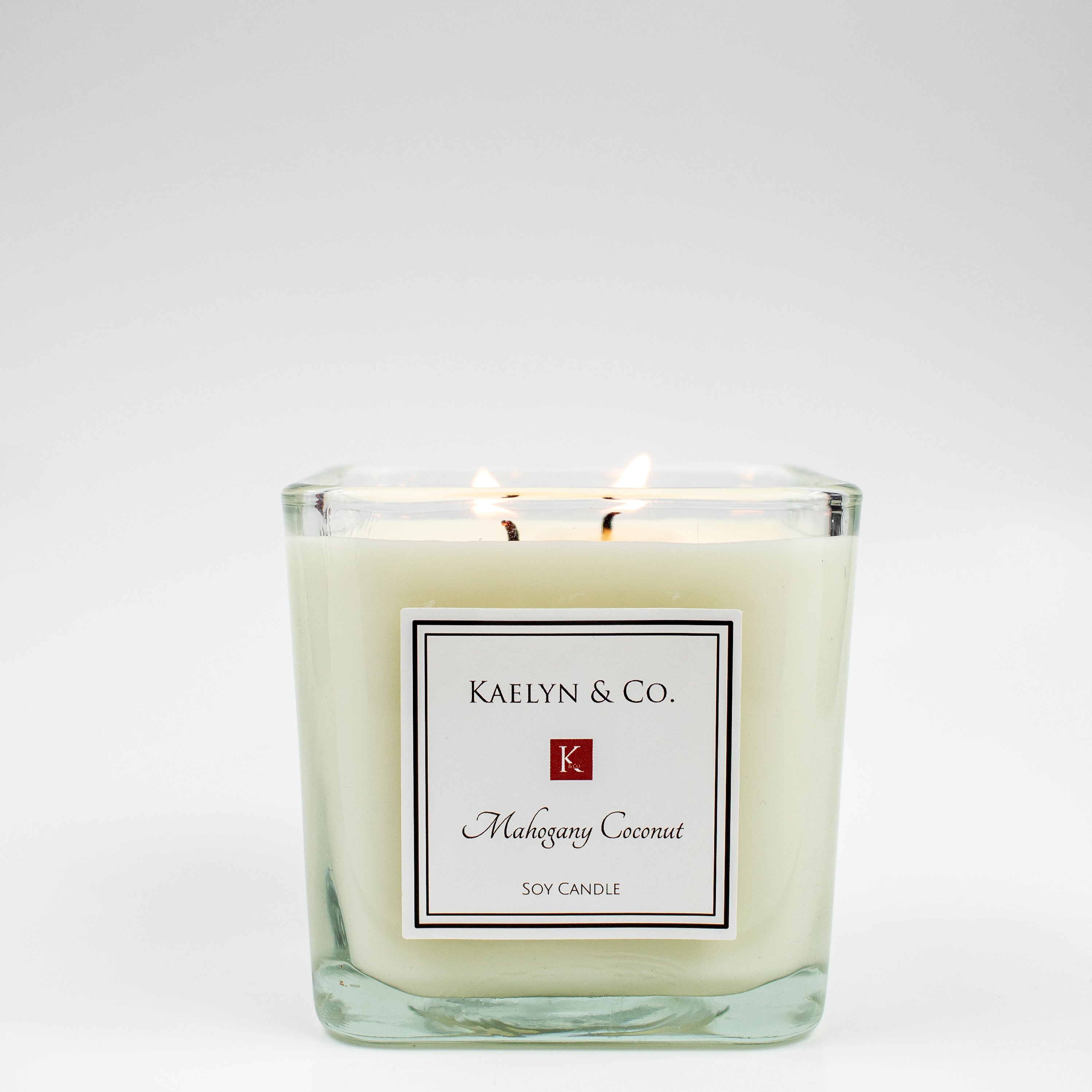 Mahogany Coconut Medium Cube Candle in an elegant gift box, showcasing its rich color and double wick design.