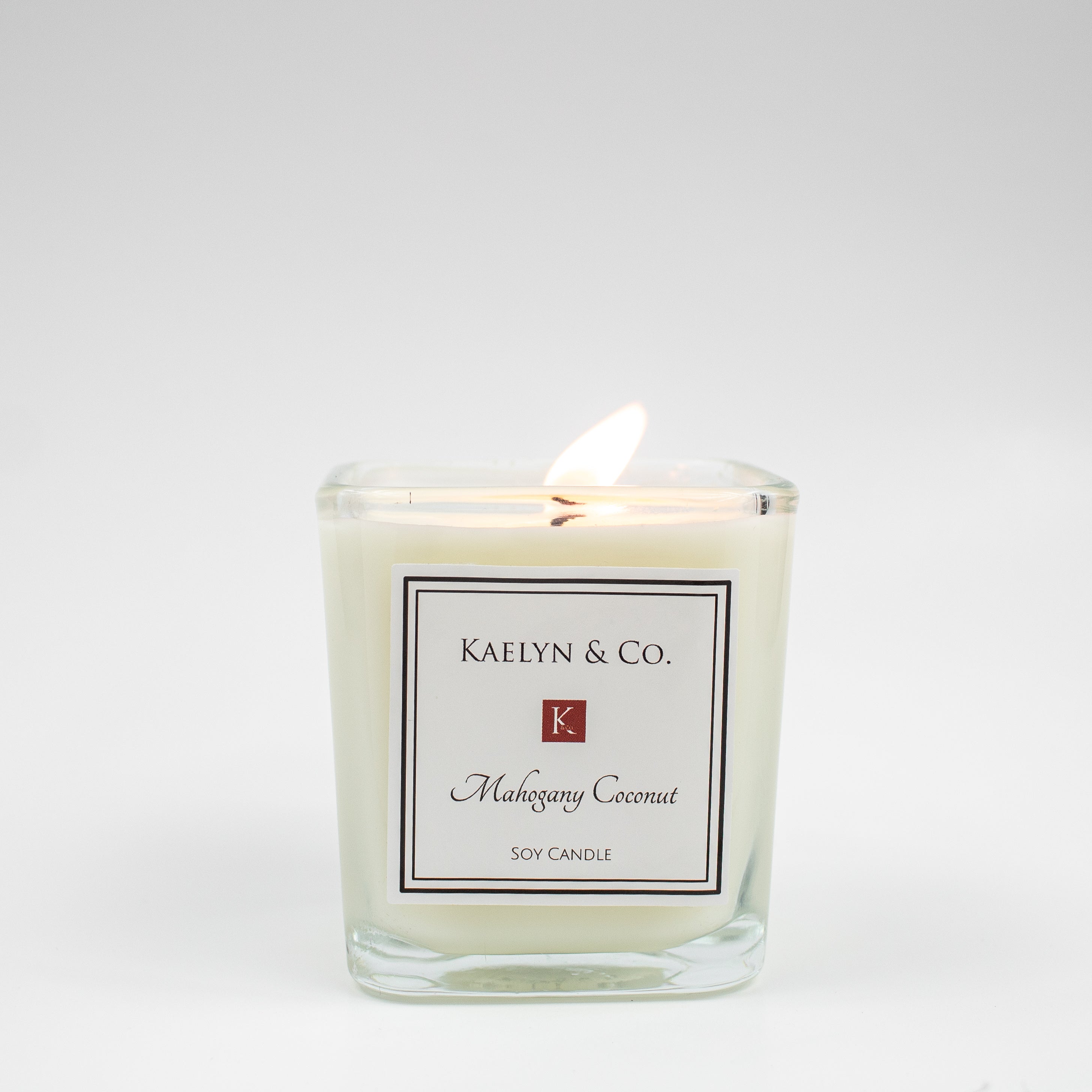 Mahogany Coconut Small Cube Candle in elegant packaging, showcasing its rich color and cube shape.