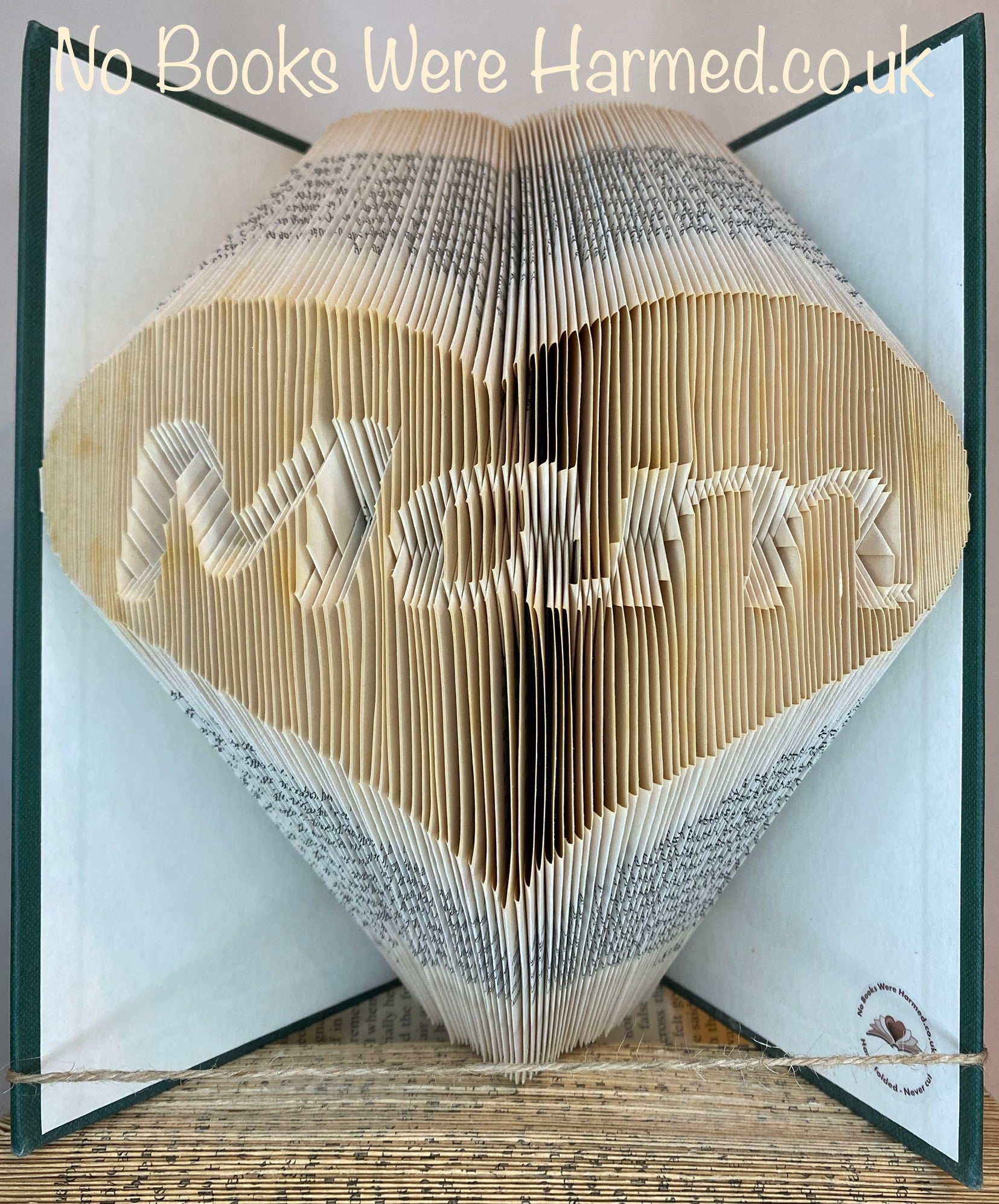 Handcrafted 'Mam' in love heart art made from vintage book pages, showcasing intricate folds and unique design.