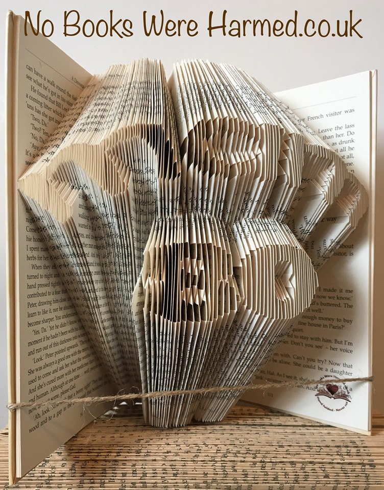 Hand-folded book art featuring the word 'Mam' over a number, crafted from vintage books.