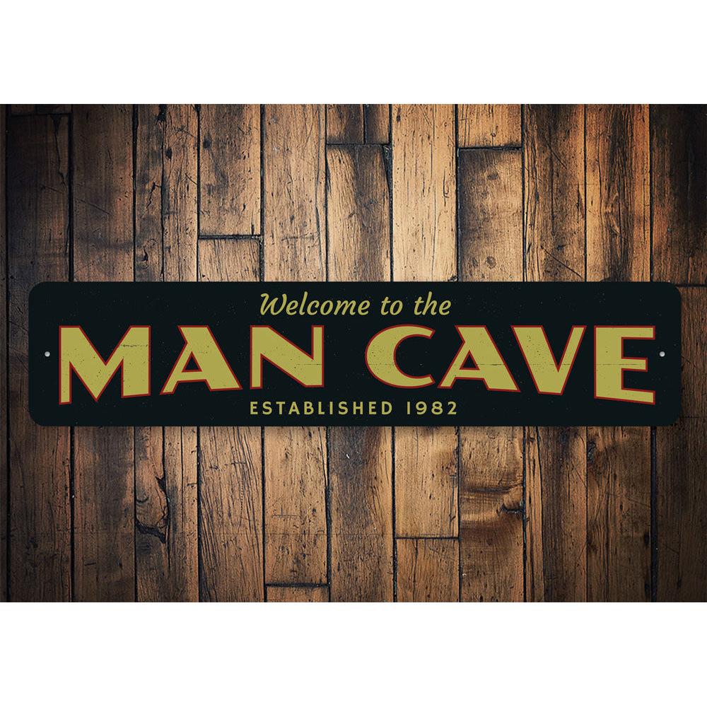 A stylish Man Cave Welcome Sign made of durable aluminum, featuring customizable text and pre-drilled holes for easy mounting.