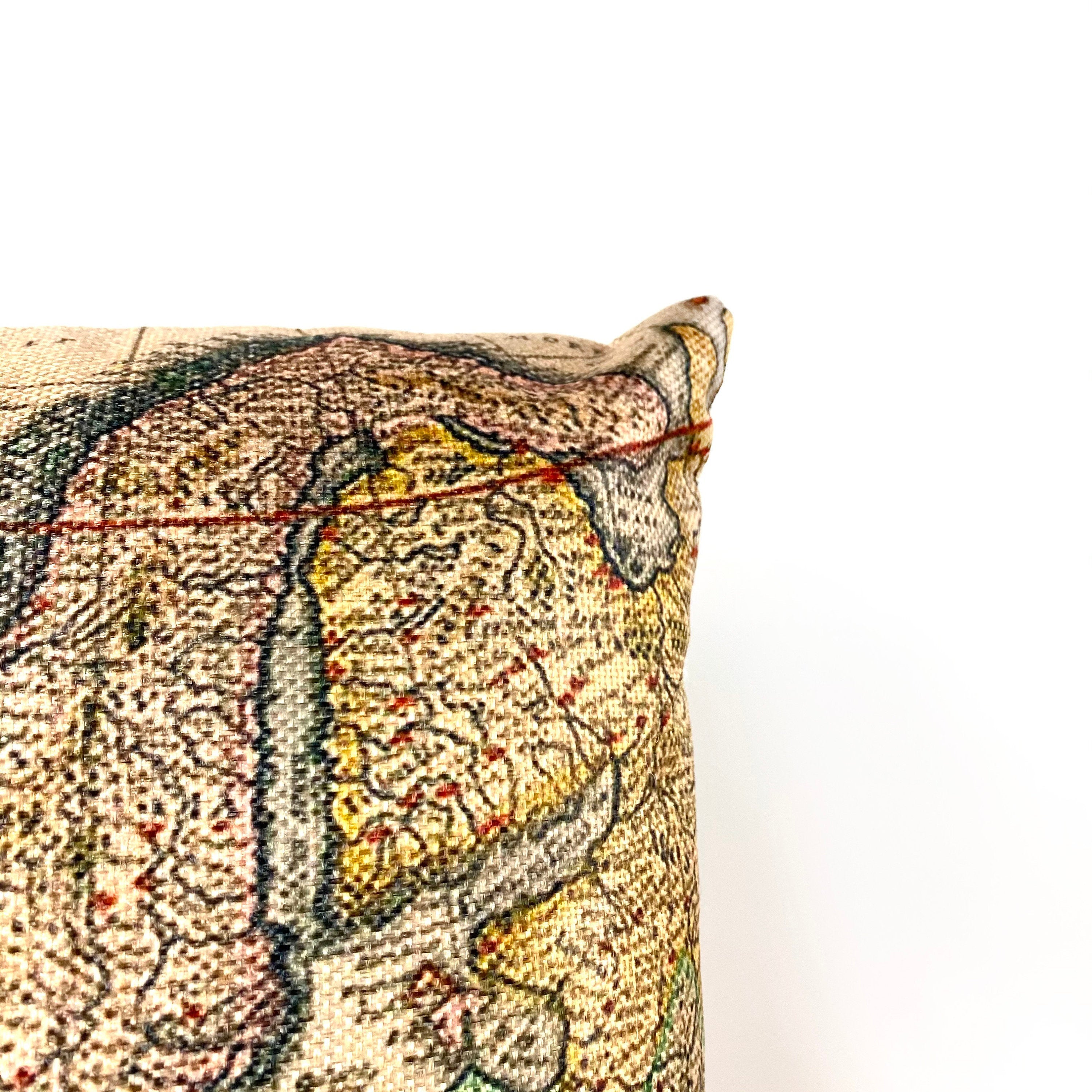 Handcrafted vintage map of Europe pillow cover on a beige background with concealed zipper.