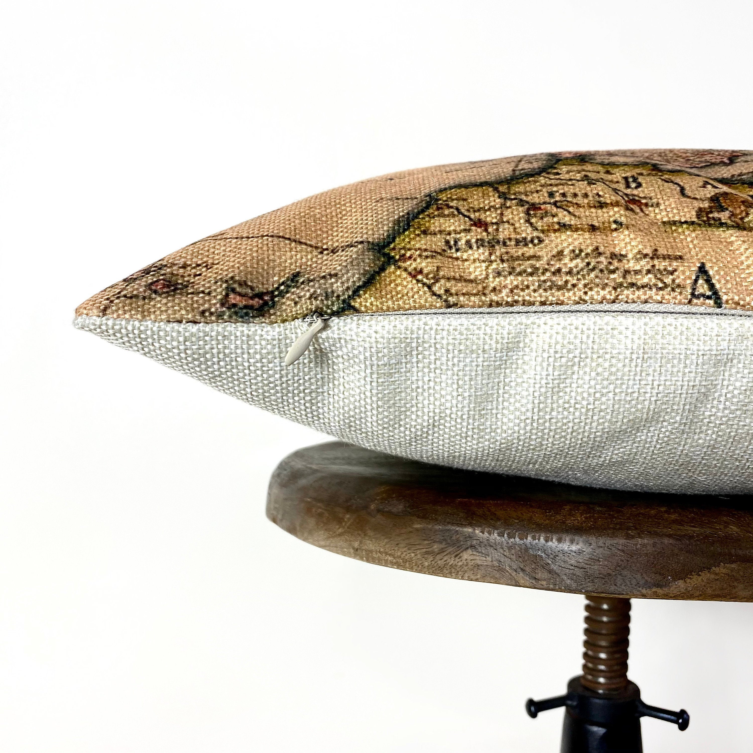 Handcrafted vintage map of Europe pillow cover on a beige background with concealed zipper.