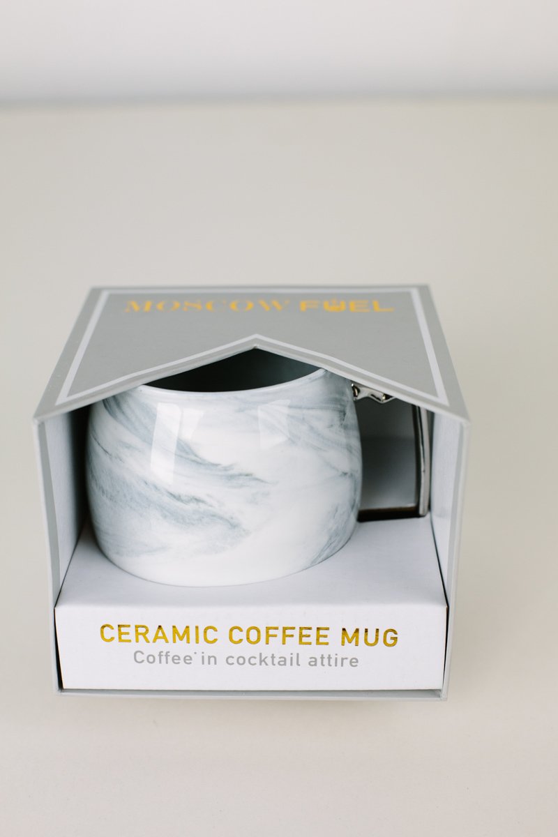 A stylish marble and silver coffee mug with a white interior, designed to resemble a Moscow Mule mug.