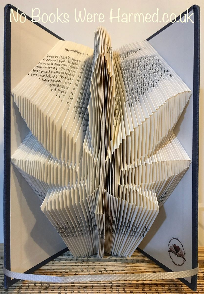 Hand-folded marijuana leaf art made from vintage book pages, showcasing intricate details and unique textures.