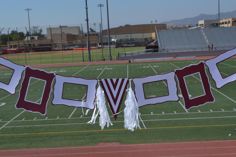 Maroon and white party decoration set featuring paper frames, pennant, ribbon, and tassels.