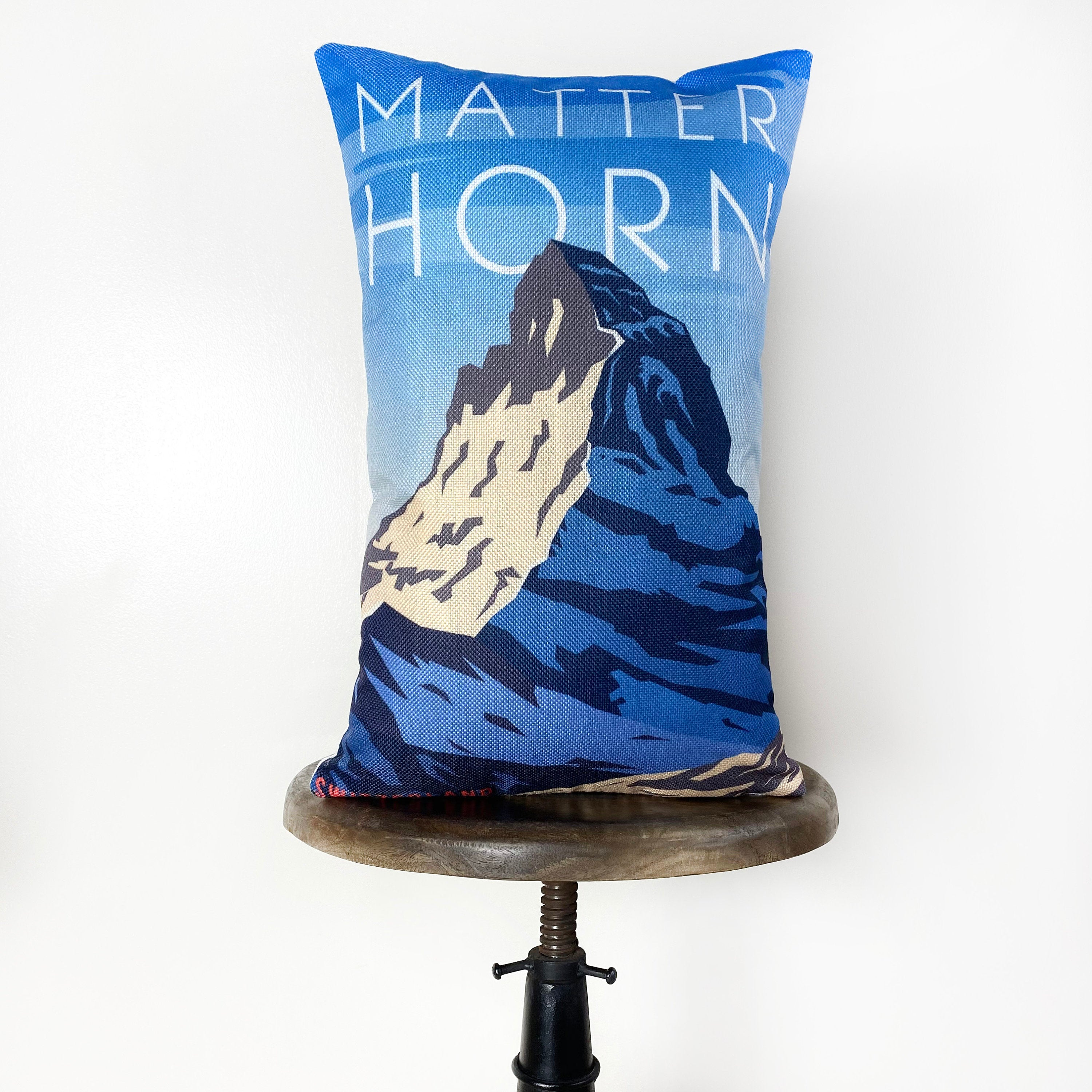 Matterhorn pillow cover featuring a vibrant travel poster design of Switzerland's iconic mountain, made from durable cotton/polyester blend.