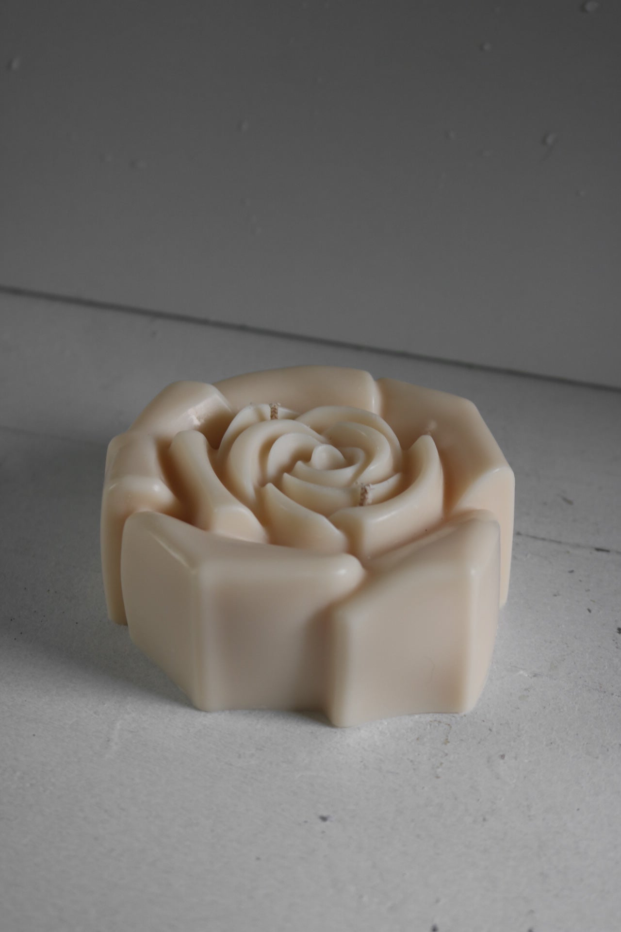 A beautifully crafted Medium Rose candle made from a soy wax blend, showcasing its sculptural design and elegant finish.