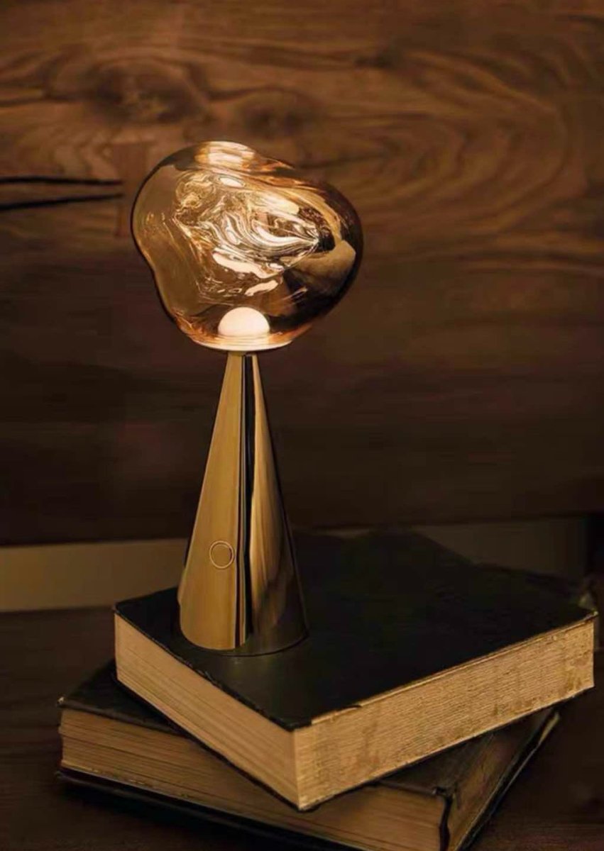 Melt Portable Dimmable LED Table Lamp showcasing a unique molten glass design with a soft glow, perfect for bedside use.