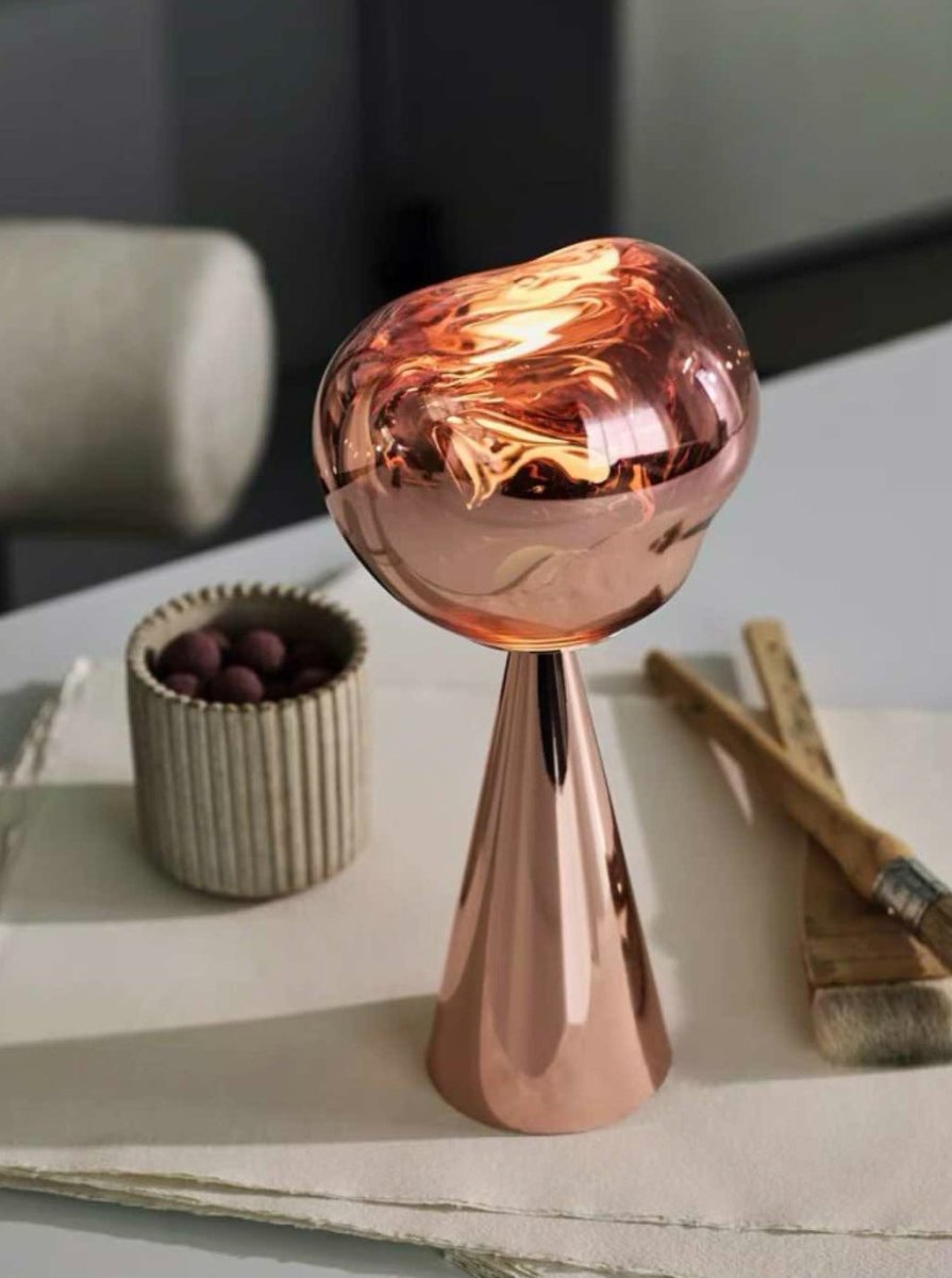 Melt Portable Dimmable LED Table Lamp showcasing a unique molten glass design with a soft glow, perfect for bedside use.