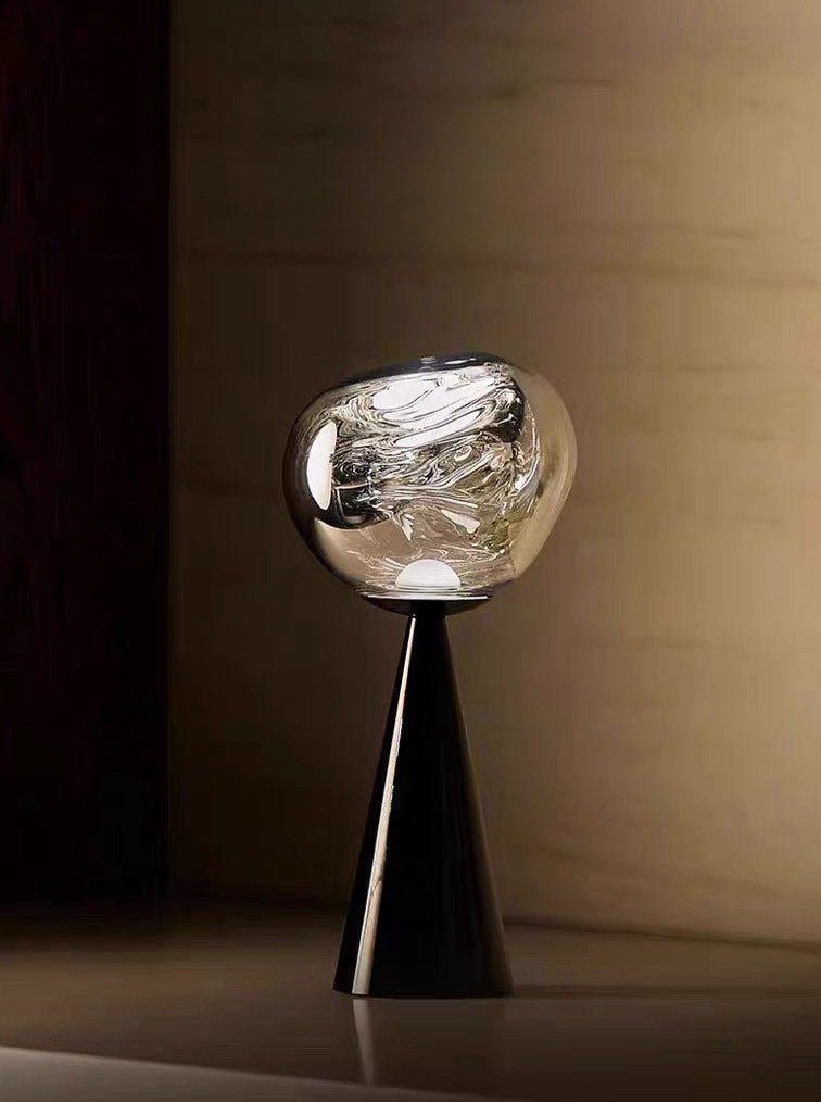 Melt Portable Dimmable LED Table Lamp showcasing a unique molten glass design with a soft glow, perfect for bedside use.