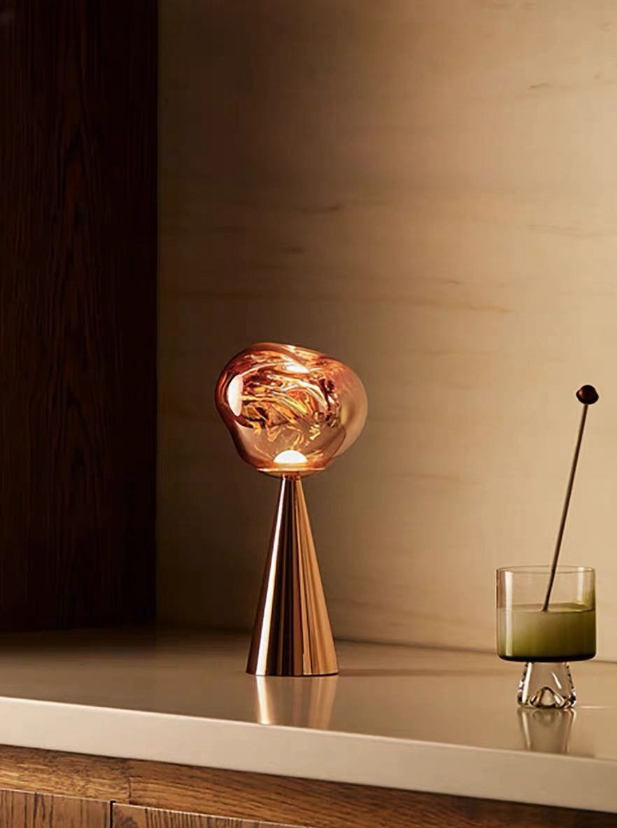 Melt Portable Dimmable LED Table Lamp showcasing a unique molten glass design with a soft glow, perfect for bedside use.