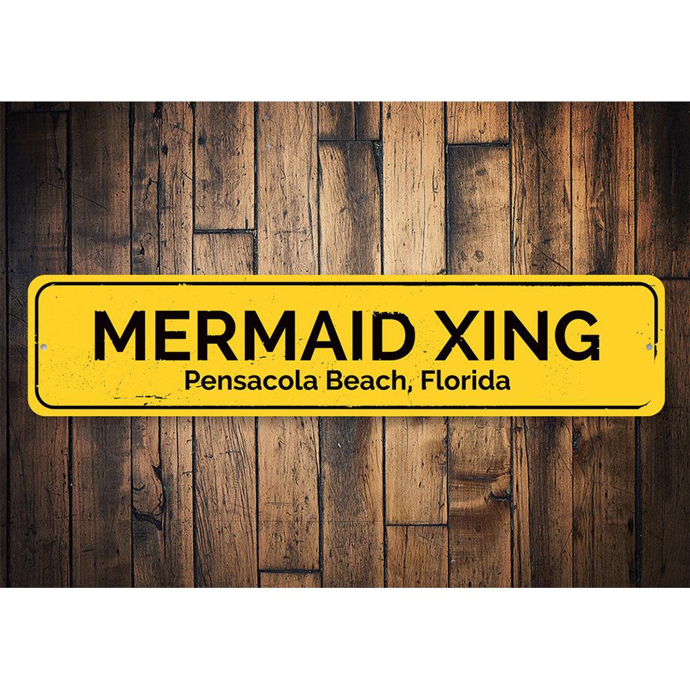 A colorful Mermaid Crossing Sign made of aluminum, featuring a whimsical design perfect for beach-themed decor.