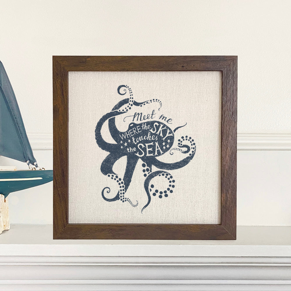 Meet Me (Octopus) framed sign with a stylized octopus design in a walnut or white-washed frame, set against a linen-look neutral background.