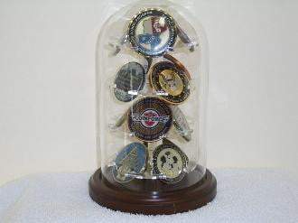 Elegant military glass dome display holding 12 challenge coins on a walnut base.