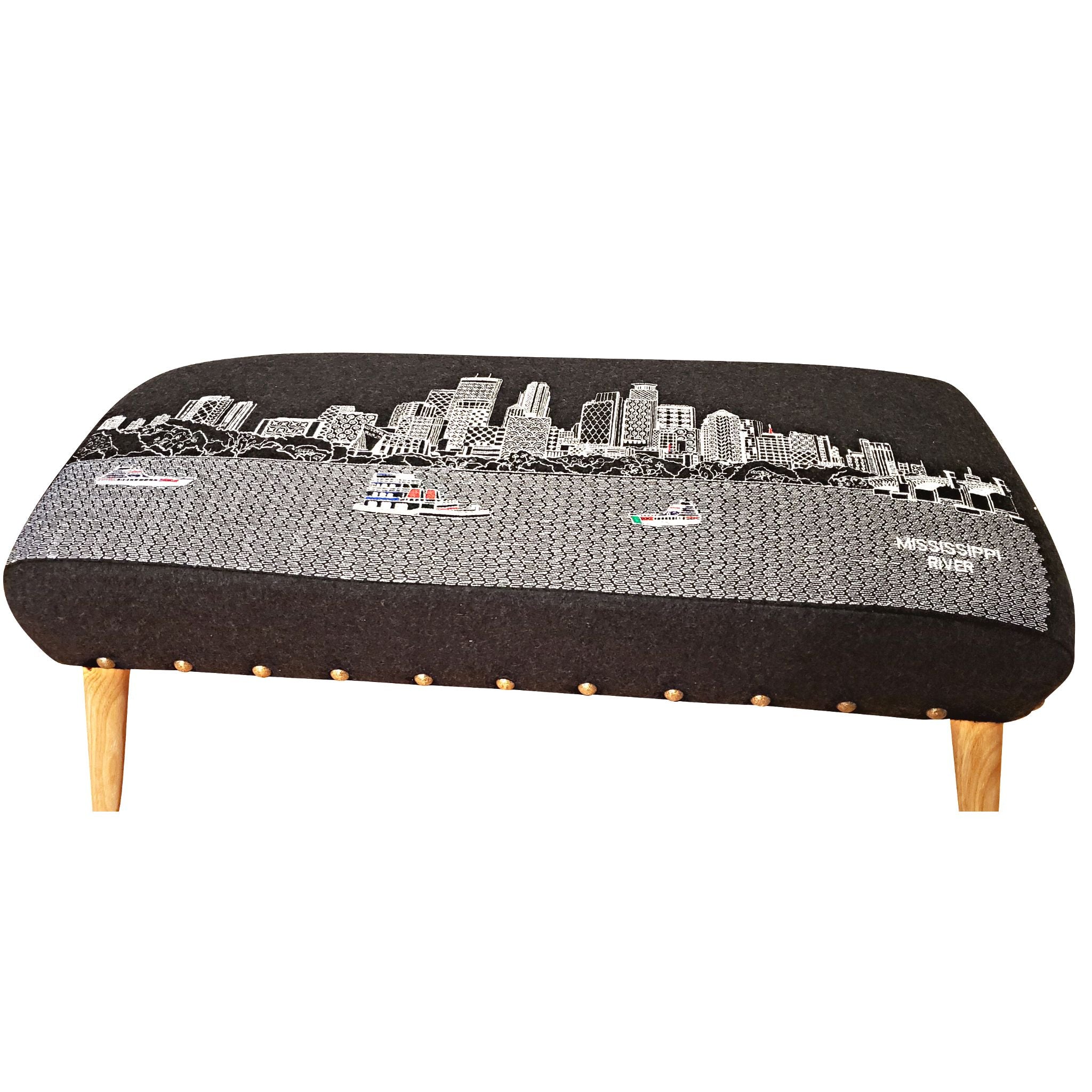 Minneapolis Ottoman featuring embroidered cityscape design with iconic landmarks, upholstered in wool with rubberwood legs.