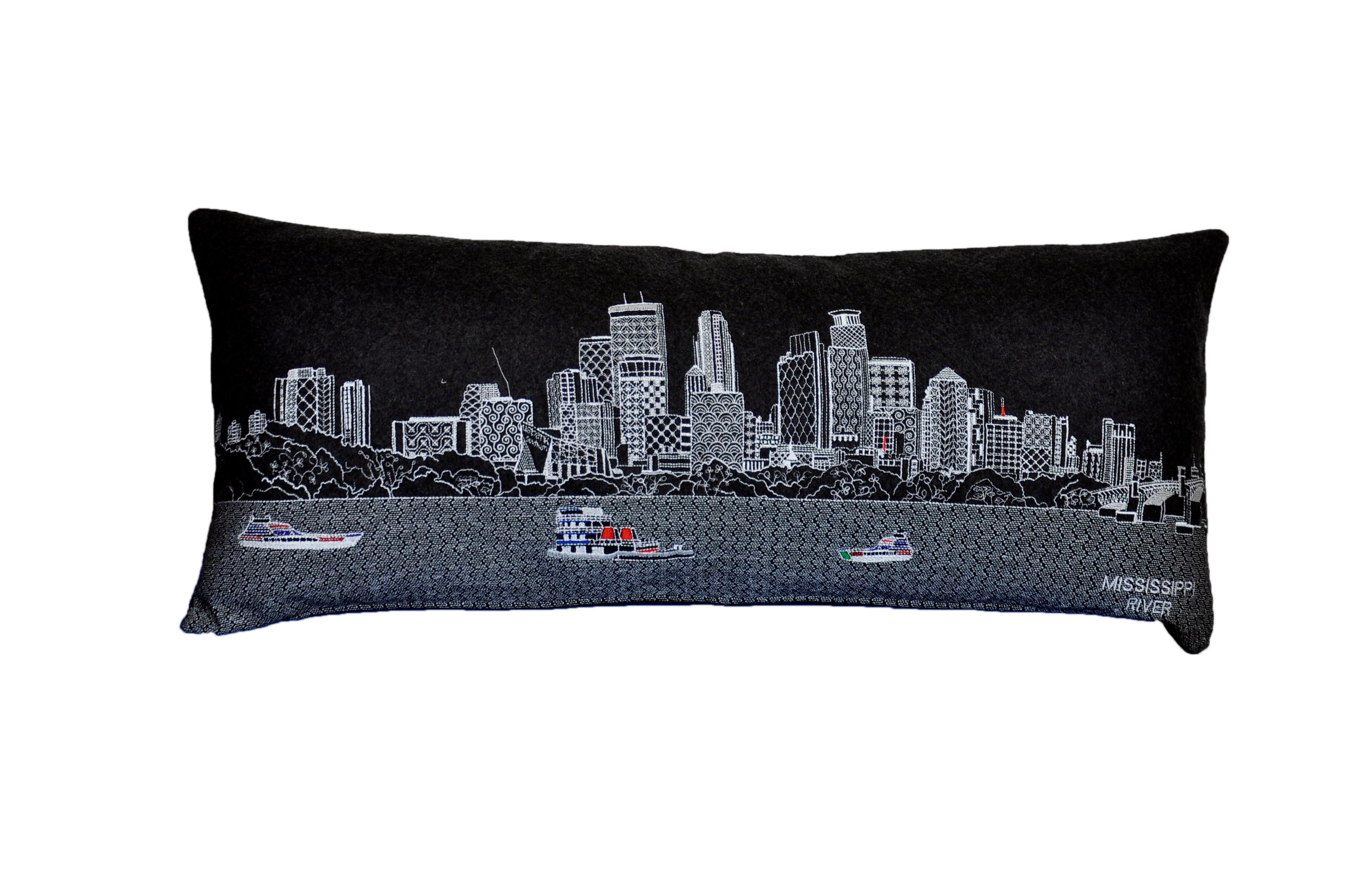 Minneapolis Pillow featuring embroidered landmarks like Foshay Tower and US Bank Stadium, with a red zipper at the bottom.