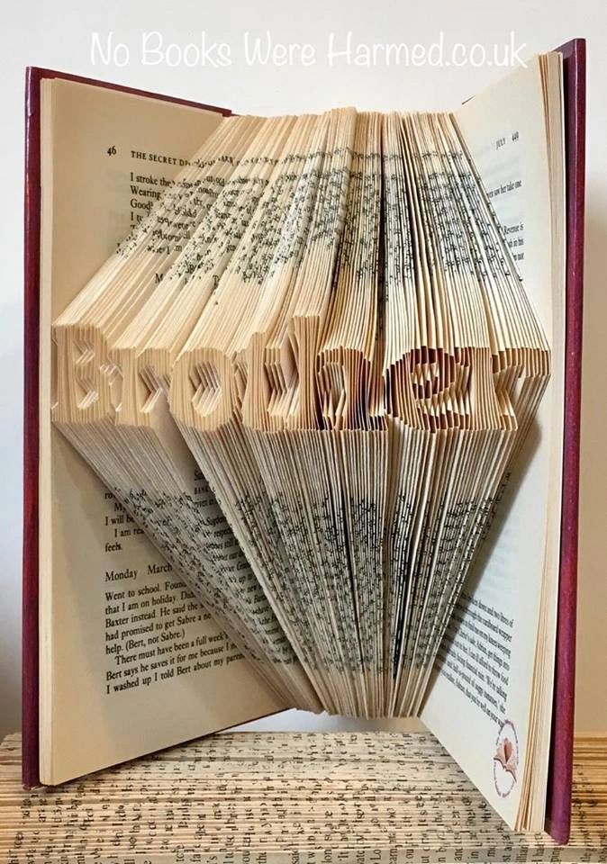 Mini 'Brother' art piece handcrafted from vintage books, showcasing intricate hand-folded pages.