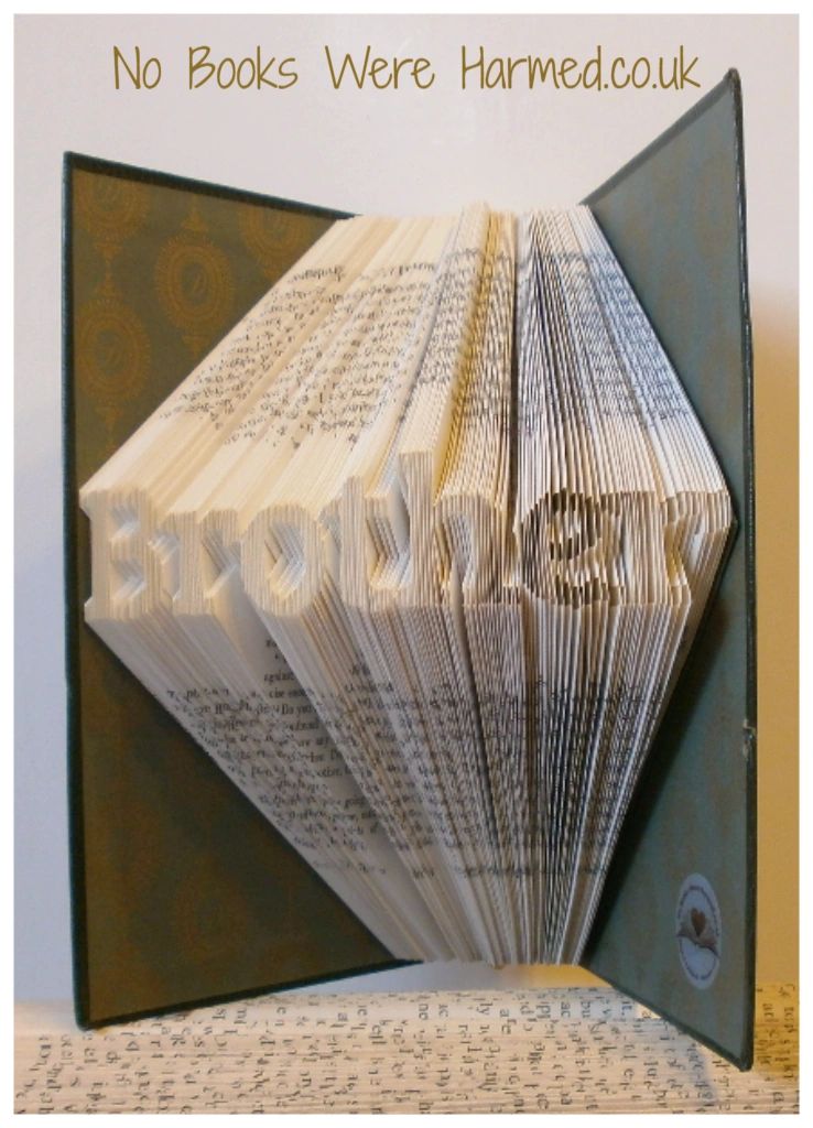 Mini 'Brother' art piece handcrafted from vintage books, showcasing intricate hand-folded pages.