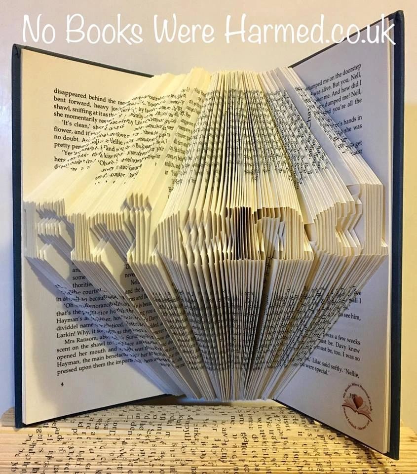 A handcrafted mini 'Friend' art piece made from vintage book pages, showcasing intricate folds and unique design.