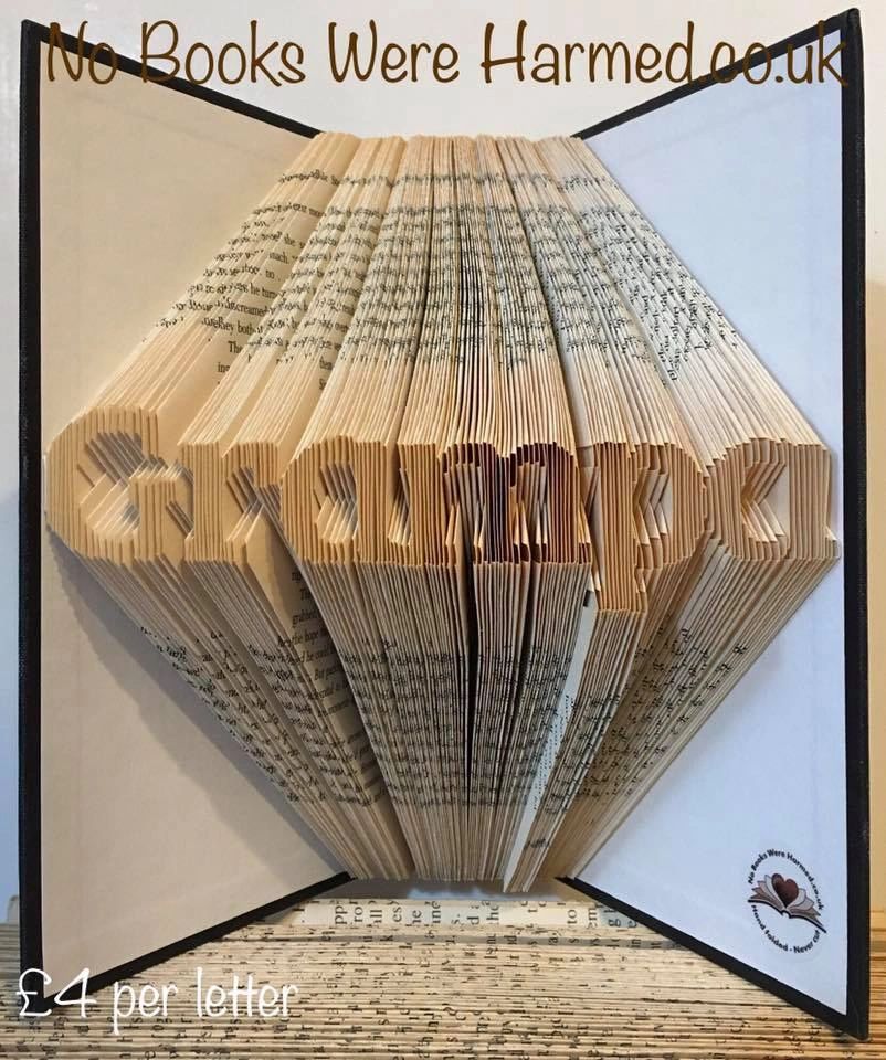 Mini 'Grampa' art piece handcrafted from vintage books, showcasing unique folds and textures.