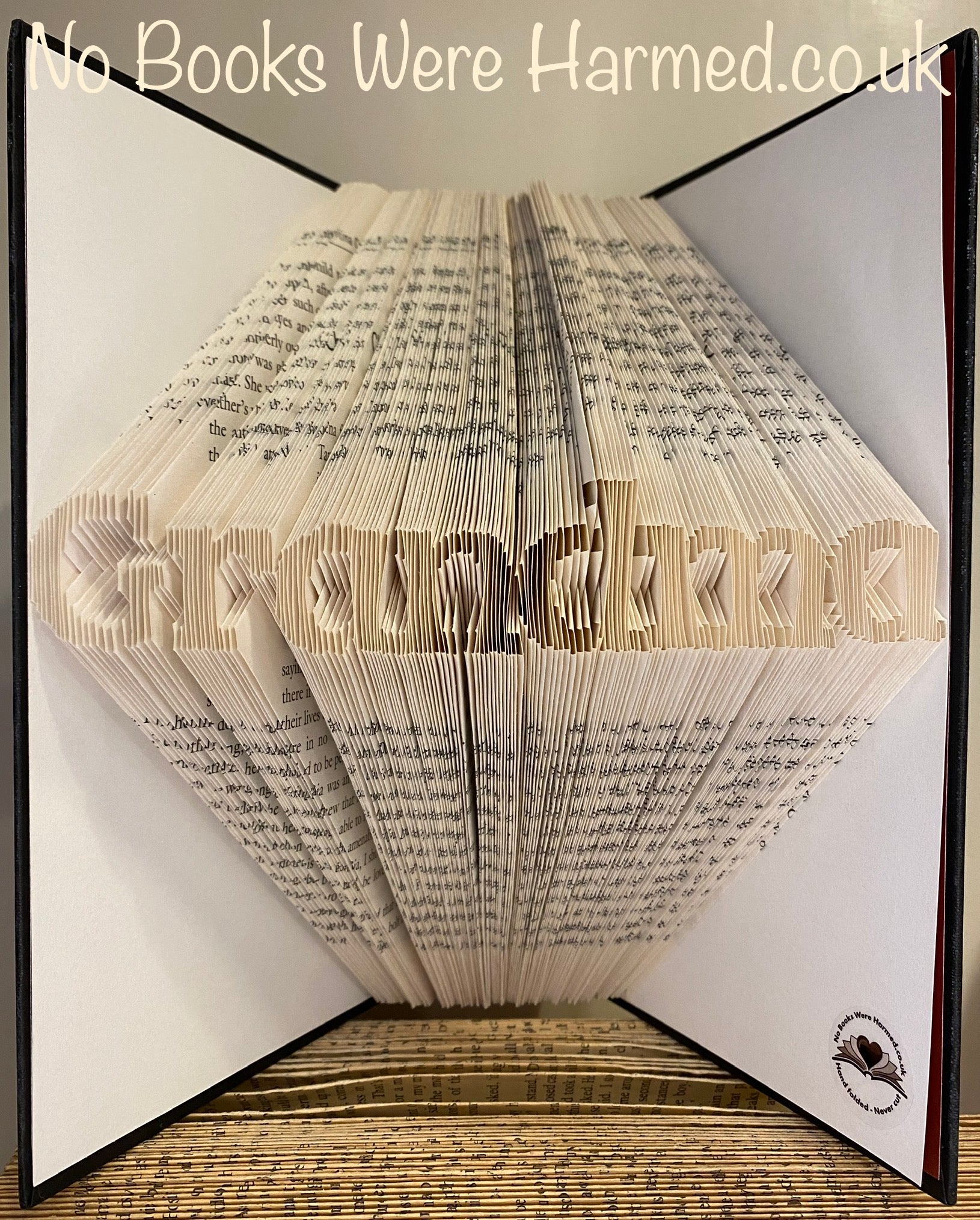 Mini 'Grandma' book art handcrafted from vintage books, showcasing intricate page folds and unique design.