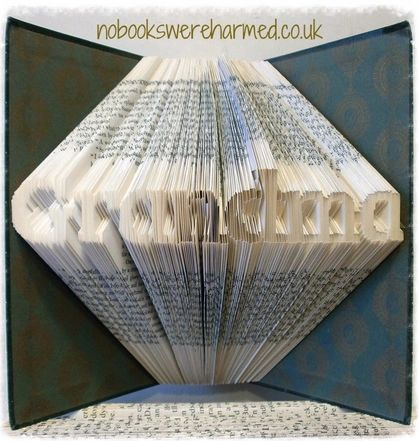 Mini 'Grandma' book art handcrafted from vintage books, showcasing intricate page folds and unique design.