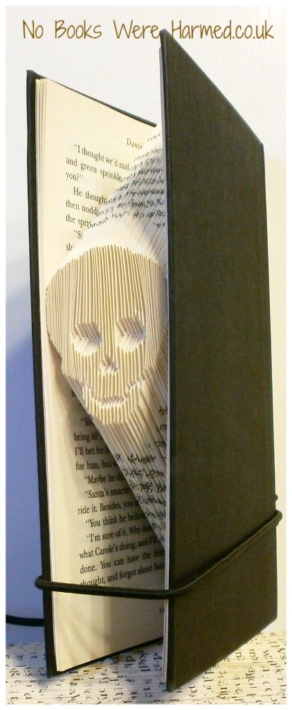 Mini Jimmy, a unique hand-folded book art piece made from vintage books, showcasing intricate folds and textures.