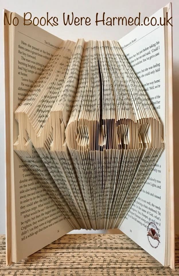 A unique Mini 'Mam' art piece made from hand-folded pages of vintage books, showcasing intricate designs and varying colors.