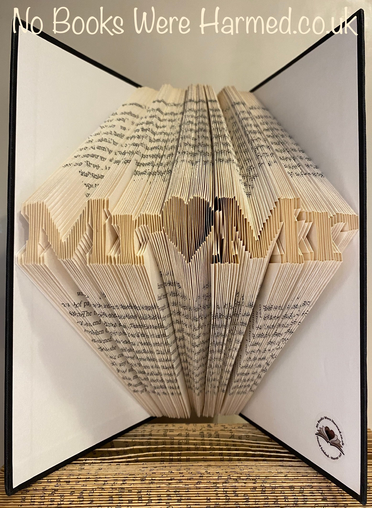 Mini 'Mr♥Mr' art piece handcrafted from vintage book pages, showcasing intricate folds and unique design.