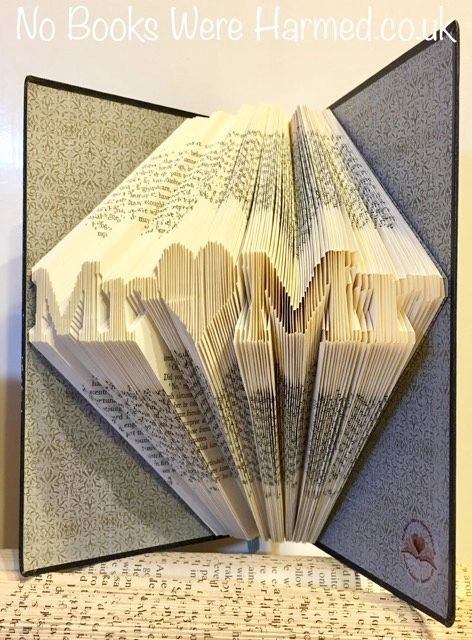 Mini 'Mr♥Mr' art piece handcrafted from vintage book pages, showcasing intricate folds and unique design.