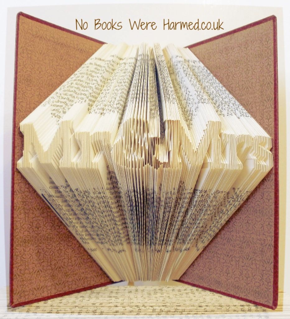 Mini 'Mr&Mrs' book art handcrafted from vintage books, showcasing intricate hand-folded pages in a unique design.