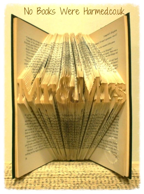 Mini 'Mr&Mrs' book art handcrafted from vintage books, showcasing intricate hand-folded pages in a unique design.