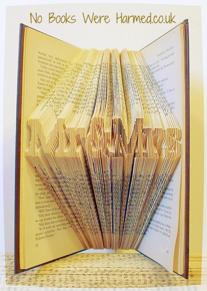 Mini 'Mr&Mrs' book art handcrafted from vintage books, showcasing intricate hand-folded pages in a unique design.