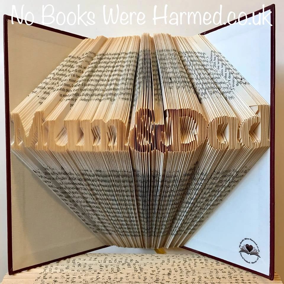 Mini 'Mum&Dad' book art handcrafted from vintage books, showcasing unique folded pages in a decorative design.