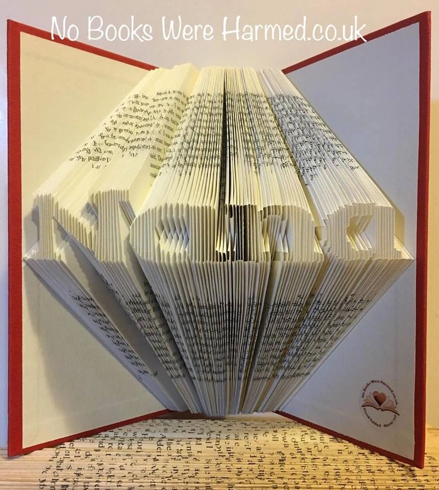 A handcrafted Mini 'Nana' art piece made from vintage book pages, showcasing intricate hand-folded designs.