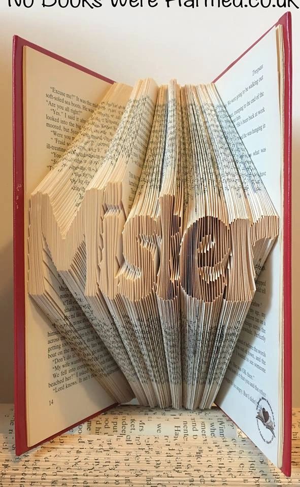 Handcrafted book art piece made from vintage books, showcasing intricate folds and unique designs.