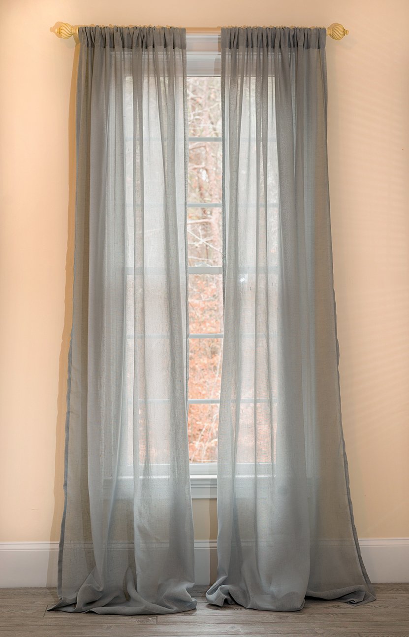 ML16606 Sierra Sheer Curtain in a light, airy fabric, elegantly draping over a window, allowing soft natural light to filter through.