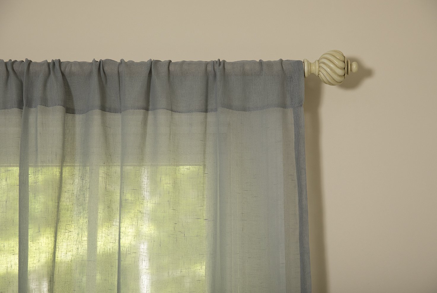 ML16606 Sierra Sheer Curtain in a light, airy fabric, elegantly draping over a window, allowing soft natural light to filter through.