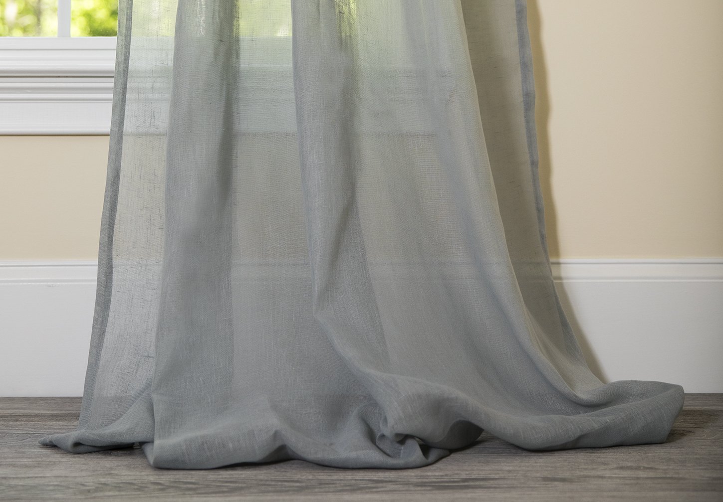 ML16606 Sierra Sheer Curtain in a light, airy fabric, elegantly draping over a window, allowing soft natural light to filter through.