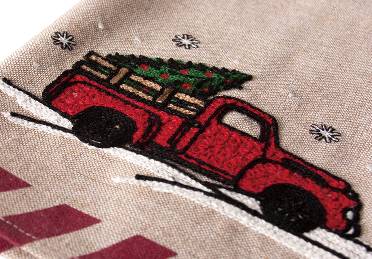 A festive Christmas tea towel featuring a whimsical red pick-up truck design, perfect for holiday kitchen decor.