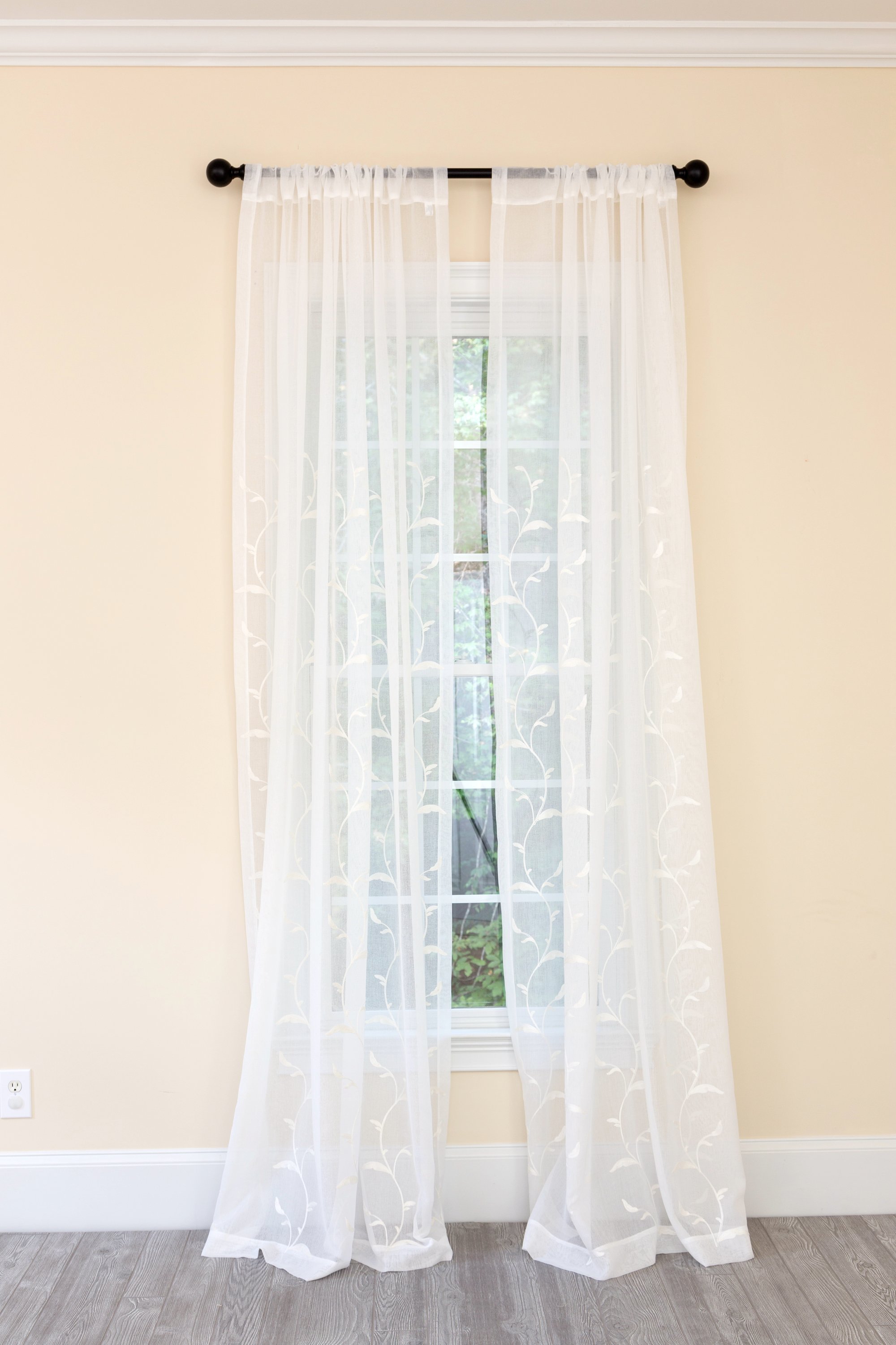 ML19011 Breeze Wavy Sheer Curtain featuring embroidered leaves on white sheer fabric, elegantly diffusing light.