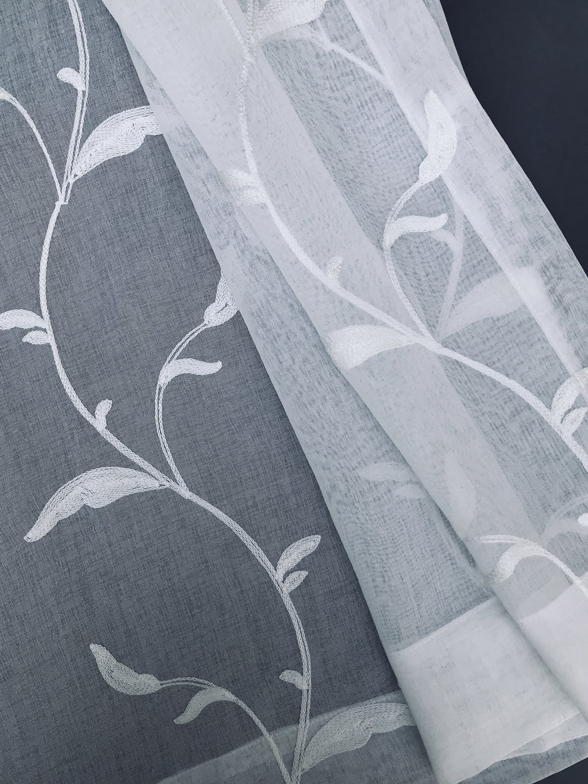 ML19011 Breeze Wavy Sheer Curtain featuring embroidered leaves on white sheer fabric, elegantly diffusing light.