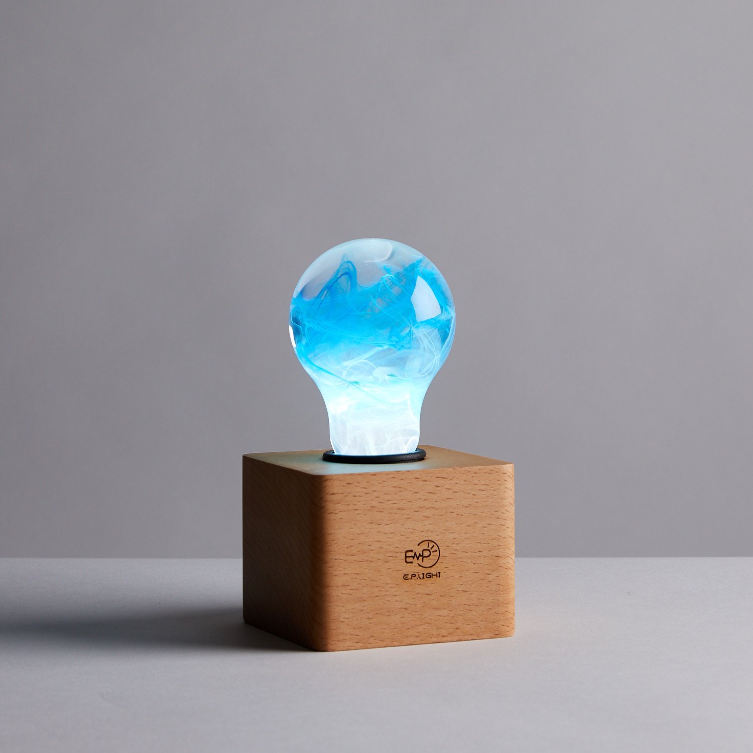 Mood Bundle featuring three eco-friendly LED bulbs in mixed colors, handcrafted from resin and beech wood.