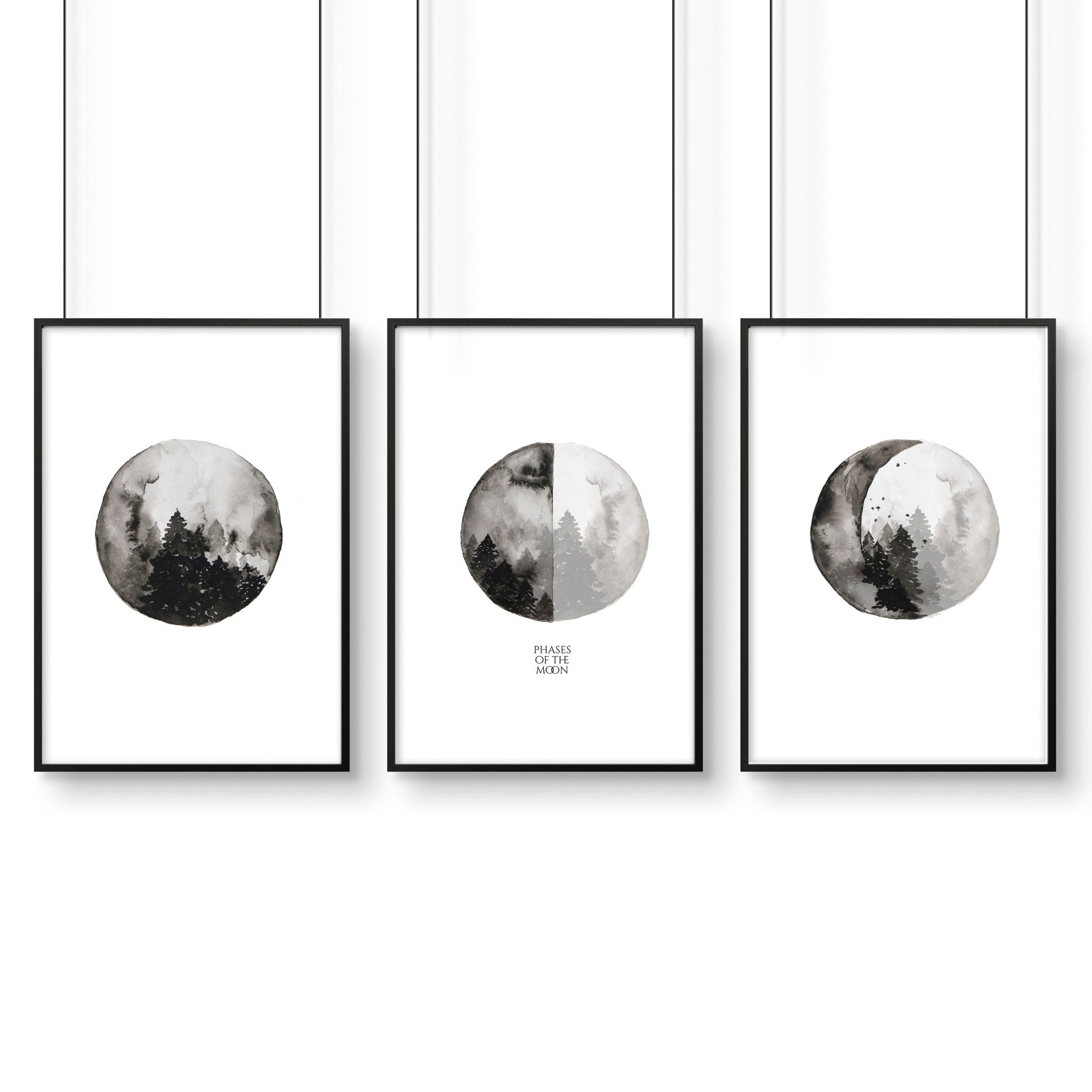 Set of 3 framed wall art prints depicting the phases of the moon in a monochromatic design, perfect for enhancing living room decor.