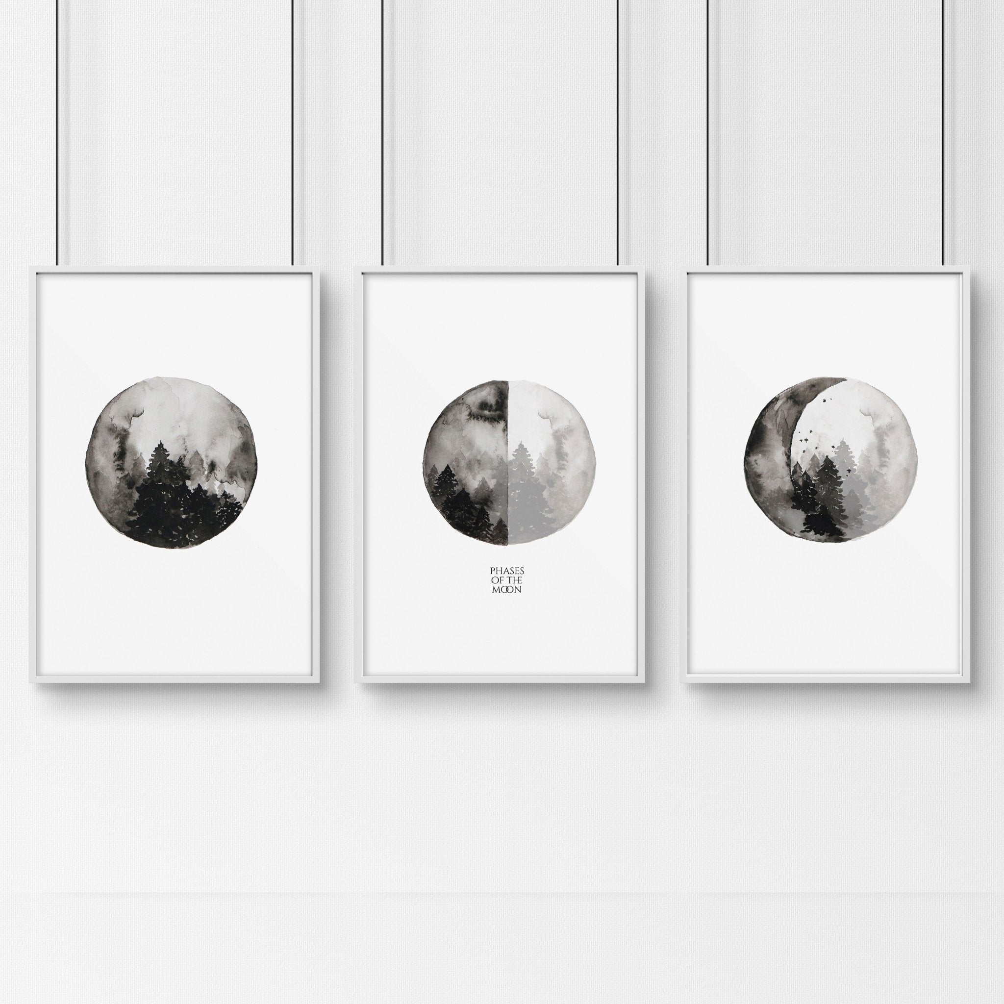 Set of 3 framed wall art prints depicting the phases of the moon in a monochromatic design, perfect for enhancing living room decor.