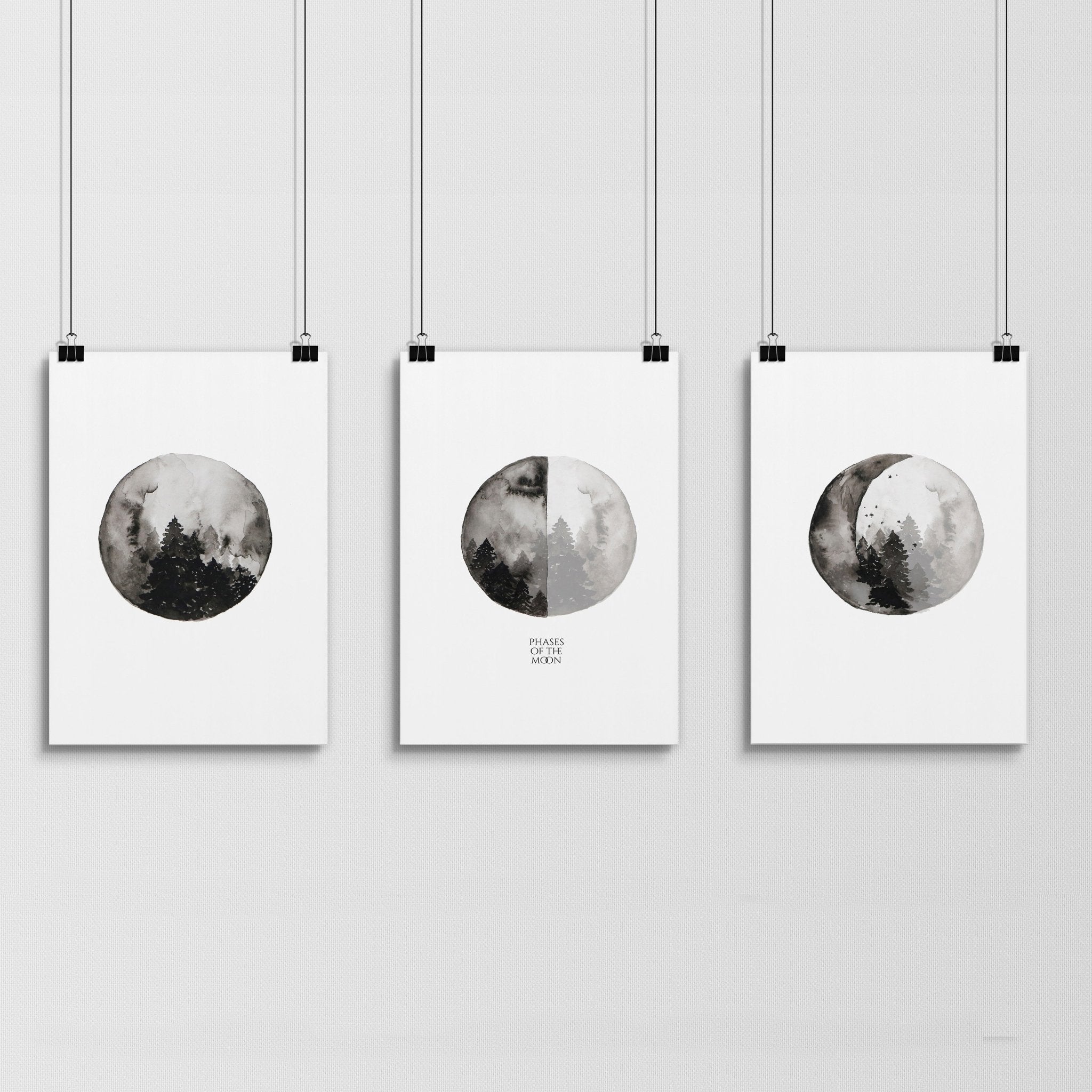 Set of 3 framed wall art prints depicting the phases of the moon in a monochromatic design, perfect for enhancing living room decor.