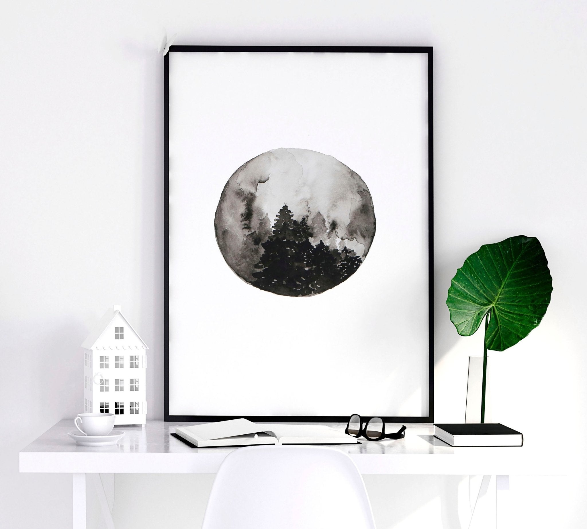 Set of 3 framed wall art prints depicting the phases of the moon in a monochromatic design, perfect for enhancing living room decor.